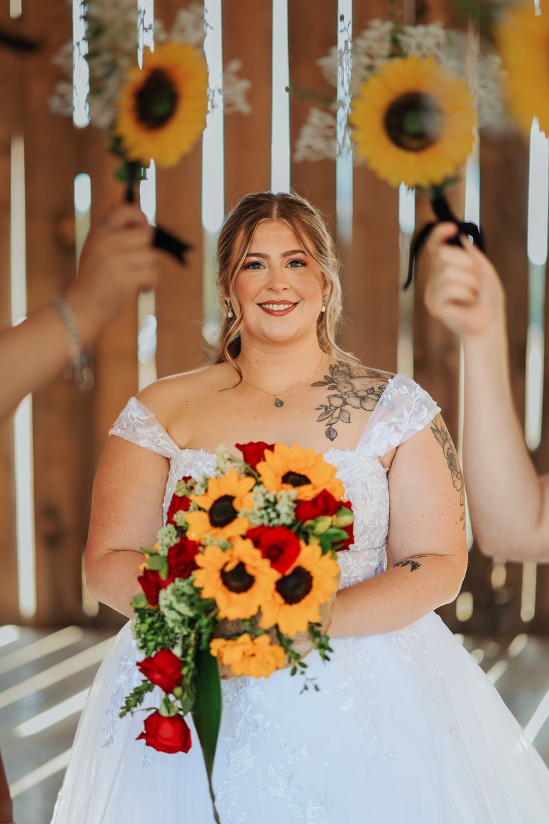 Rebecca smiling with sunflowers
